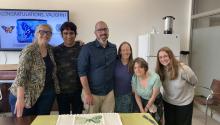 Dr. Shirey (middle) with Dr. Ries (far left) and other Ries lab members at post-defense celebration (With Cake)